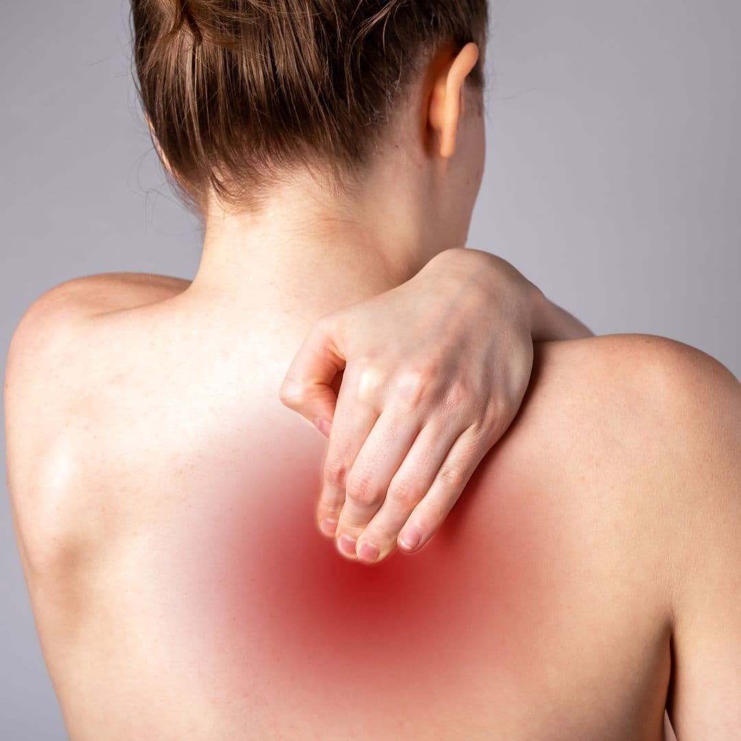 Chiropractor examining a patient's shoulder and cervical spine in Fernley, NV